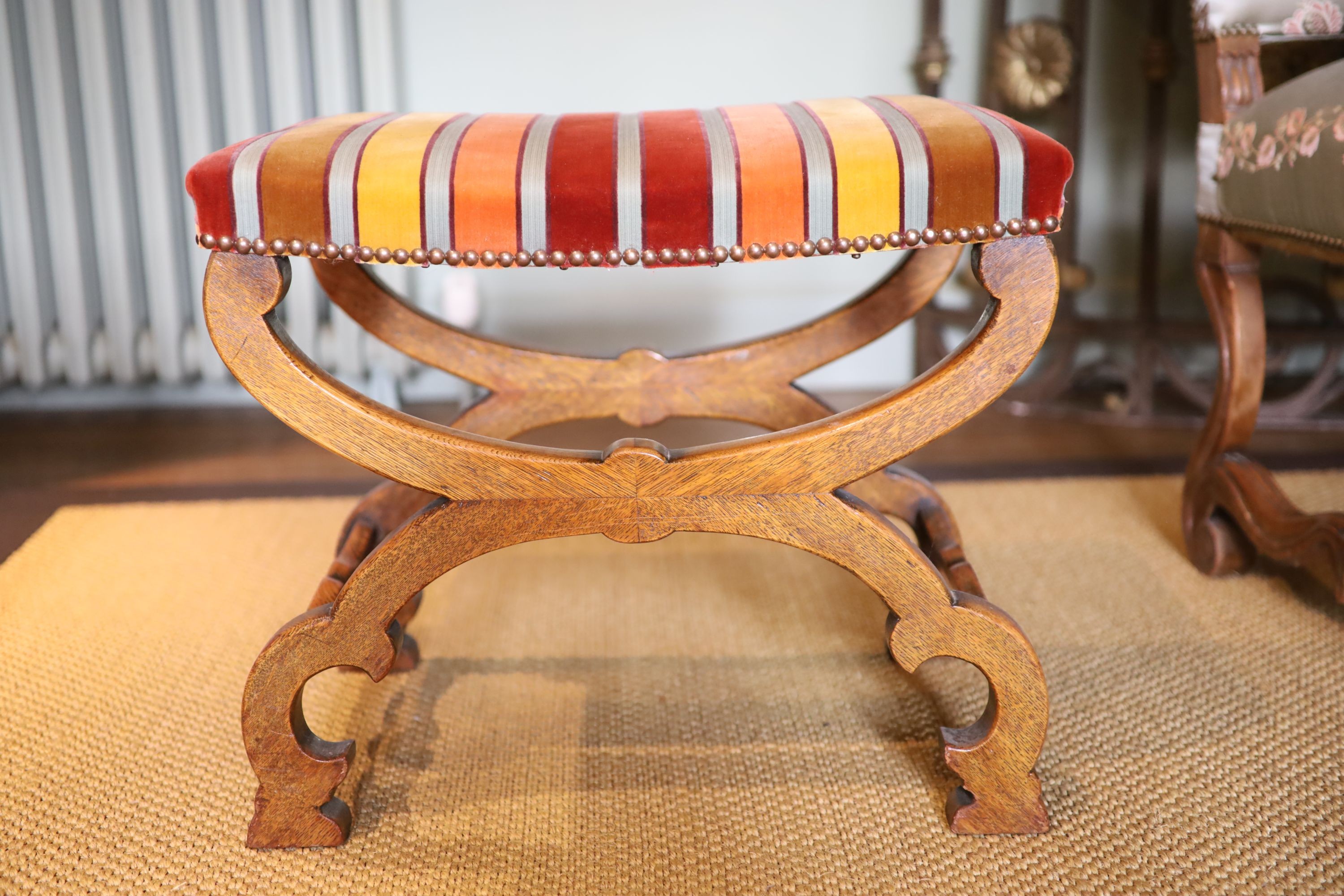 A Victorian X frame oak foot stool, with striped fabric upholstery, 54 x 40cm height 45cm